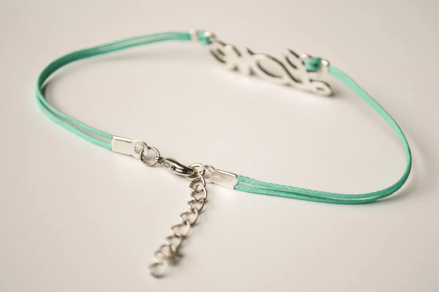 Dainty turquoise cord anklet with a silver love charm