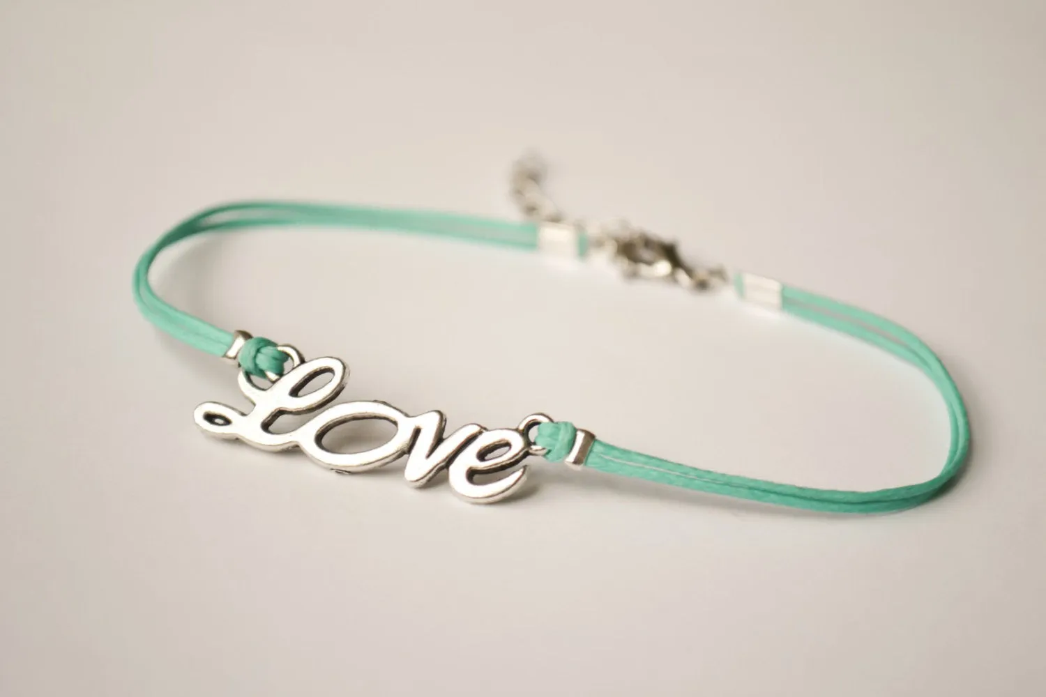 Dainty turquoise cord anklet with a silver love charm